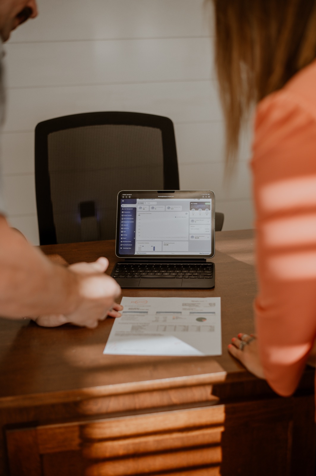 A merchant processing statement displayed on a tablet during a review